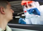 coronavirus test being administered to white man in car